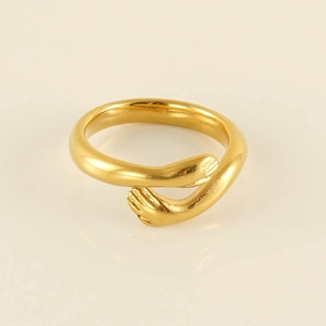 Macro shot of 18k gold plated hug ring showing detailed polished hands and smooth metal finish