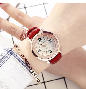 Detail of elegant quartz watch with red leather strap and matching gold roman bracelet