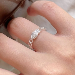 Close-up of 925 sterling silver ring with oval zircon inlay and hollow circular patterns