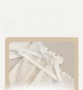Detail of off-white socks with ruffle edges and delicate silk bows in sweet Lolita style