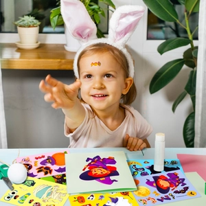 Child playing with Halloween puzzle stickers featuring pumpkins and ghosts for DIY fun