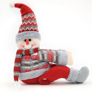 Charming knitted Christmas snowman doll in red and white stripes sitting on white background