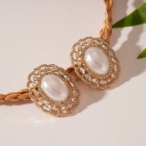 Macro detail of oval faux pearls and rhinestones on a woven cord belt accessory