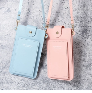 Detail of light blue and pink PU leather crossbody phone bags with metal hardware