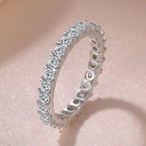 Macro detail of silver eternity ring with round-cut sparkling cubic zirconia stones