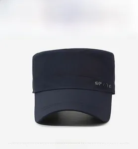 Detail of navy blue flat top military cap with white sports embroidery and reinforced stitching
