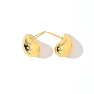 Macro shot of 14K gold plated water drop earrings with high polish metallic finish
