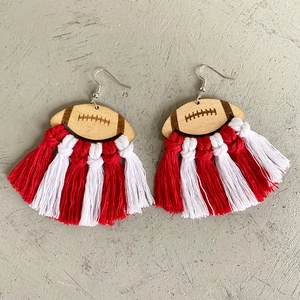 Detail of rugby wood earrings with handcrafted red and white cotton fringe tassels