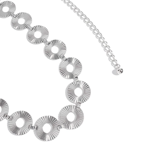 Detail of silver punk waist chain featuring radial textured metal rings and extension link