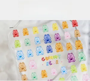 Close-up of colorful gummy bear nail art stickers with gummy bear text on transparent film
