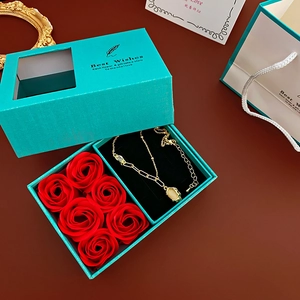 Tiffany blue jewelry gift box set with six red roses and a gold necklace detail