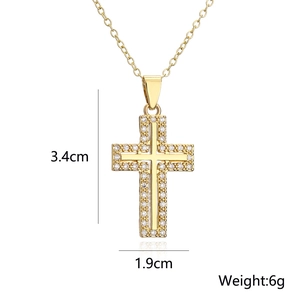Detailed view of gold cross pendant with cubic zirconia, dimensions 3.4cm by 1.9cm