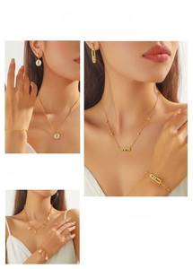Detail of pink floral pendants and sliding diamond jewelry set in golden finish