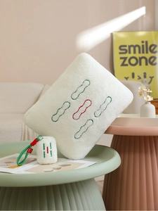 Creative Mahjong Wu Tong plush pillow with matching keychain on a decorative table
