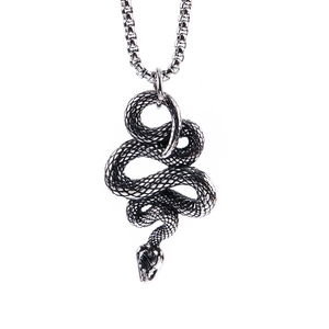 Detailed view of silver snake pendant with textured scales and oxidized vintage finish