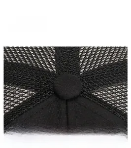 Close-up of black breathable mesh fabric and top button on a sun protection outdoor hat