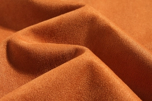 Macro view of caramel suede fabric texture showing premium micro-fiber fiber details