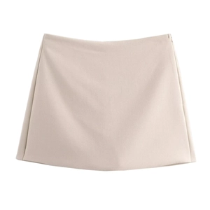 Detail view of the apricot A-line skort showing fine woven fabric and hidden side zipper
