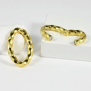 Macro view of gold plated twisted metal buckle showing the internal magnetic closure