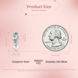 S925 sterling silver heart bead with purple stones next to a quarter for scale