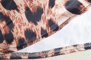 Close-up of leopard print dress hem featuring precise double-stitch sewing detail