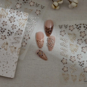 Modern minimalist leopard and floral nail art stickers in earthy brown tones on fabric