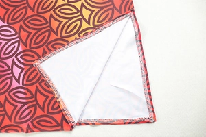 Detail of side slit and precise stitching on the colorful gradient print mini dress