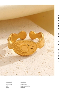Detail of gold vintage textured ring with hammered finish on natural stone background