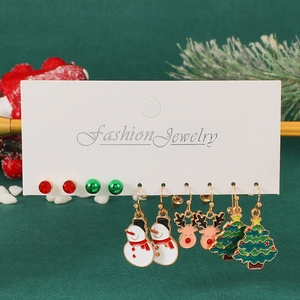 Detail showing five pairs of Christmas earrings including snowman and tree on card