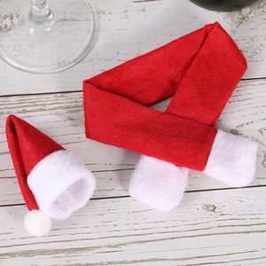 Detailed view of mini Christmas hat and scarf set in soft red and white fleece material
