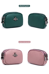 Detail of multi-zip leather coin purses in green and purple with metal bee accents