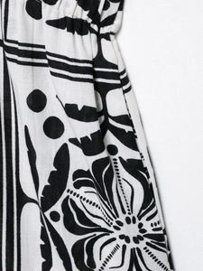 Detail of bohemian black and white plant print fabric with elastic waist and linen texture
