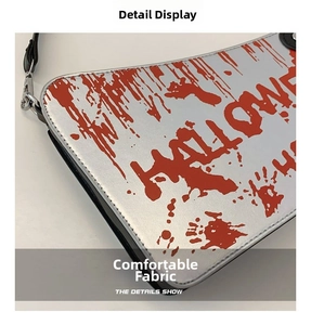 Detail of cleaver shaped clutch with blood splatter print and Halloween lettering