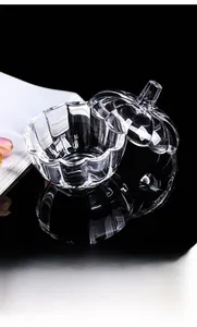 Exquisite pumpkin-shaped crystal glass container with lid on a reflective black base