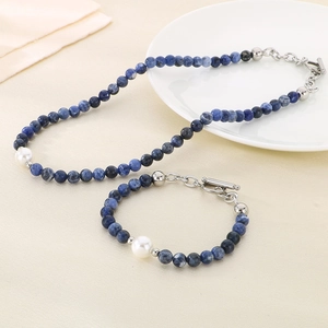 Detail of beaded jewelry set featuring 6mm blue stones and white pearl with silver toggle clasp