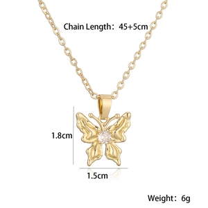 Detail view of gold butterfly pendant with clear zircon showing 45+5cm chain length specs