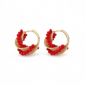 Elegant gold twisted hoop earrings with layered vibrant red glass bead embellishments