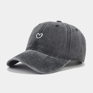 Close-up of fine heart embroidery on vintage washed charcoal grey baseball cap