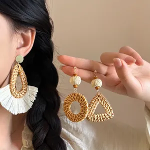 Bohemian raffia teardrop earrings with cotton tassels and geometric straw design