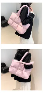 Detailed side view of a pink quilted puffer tote bag with puffy square pattern texture