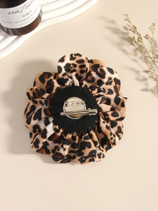 Detail view of leopard print fabric rose brooch showing silver metal pin and clip back