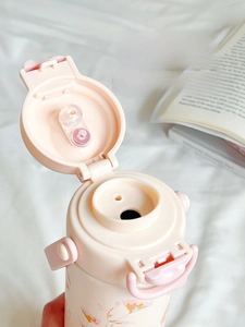 Detailed close-up of pink dual-sip thermal bottle lid with straw and direct drink ports