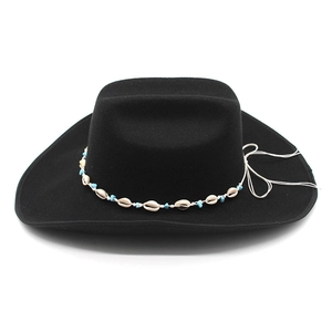 Close-up of black felt cowboy hat with ethnic shell and turquoise bead hatband detail