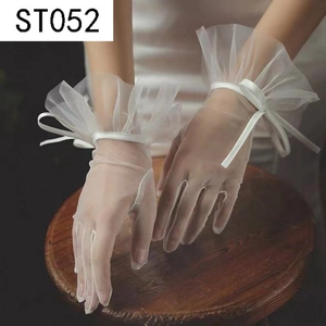 Elegant white tulle bridal gloves with ruffle cuffs and decorative bows for weddings