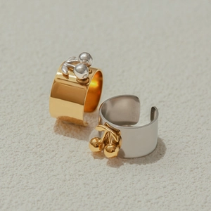 Detail of 18k gold plated stainless steel open ring with cherry charm decoration