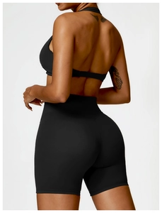 Detail view of the open-back sports bra and high-waist yoga shorts in black