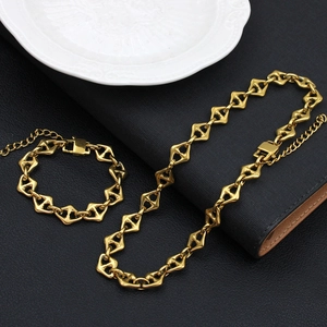 Golden geometric necklace and bracelet set with diamond and triangle links on black leather
