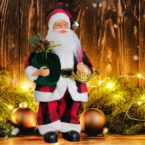 Detailed close-up of a standing Santa doll with a green gift bag and gold horn ornament