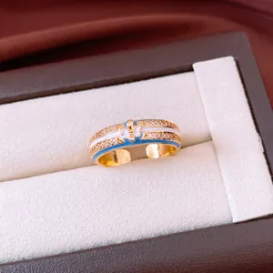 18k gold plated adjustable ring with blue enamel fleur-de-lis and sparkling crystals