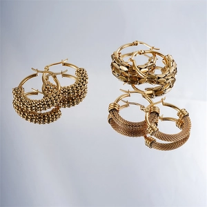 Three pairs of gold stainless steel geometric hoop earrings with textured finishes